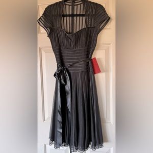 This is such a beautiful dress and very becoming! Sheer details over skirt.